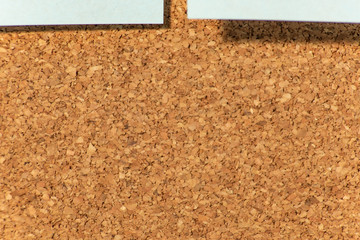 Blue paper sheet on cork board from above is macro