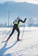Isolated athlete during an amateur cross country ski race in a sunny day