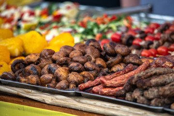 Ukrainian country fair cooking roasted potatoes cooked outdoors cookout vegetable meals fresh organic, healthy snack cooked on grill flame. Street fast food.