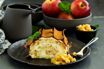 Roulade with apples and caramel, cream. New Year's dessert. Selective focus
