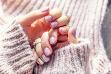Art nail manicure for bride in purple sweater. Gel nails in soft pink color