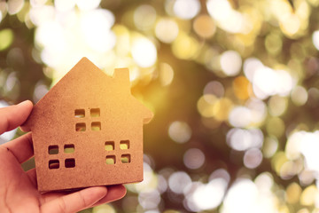 Copyspace model of a little house that woman holds it background.