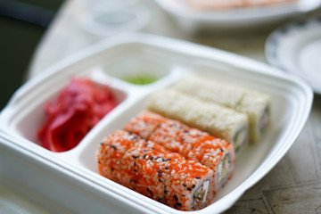 delivery service Japanese food rolls in plastic box