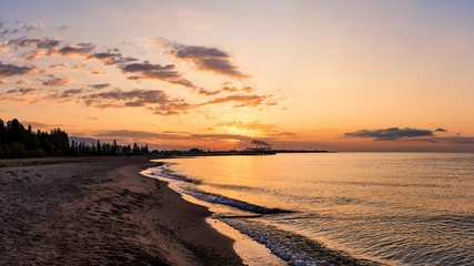 Beautiful panoramic view of the beach at dawn, lit by morning sunlight, luxurious summer adventures, outdoor activities, tourism
