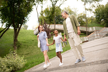 Fototapeta premium Happy family walking in the city at the weekend