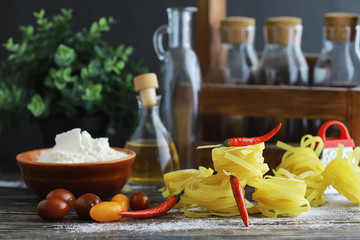 Pasta uncooked on the table. Noodles in the form of nests.