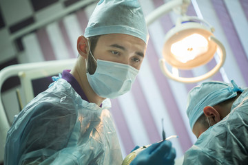 Dentist doctors making surgery. Dental manipulation in clinic