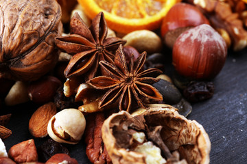 Composition with dried fruits and assorted healthy nuts on rustic background for christmas