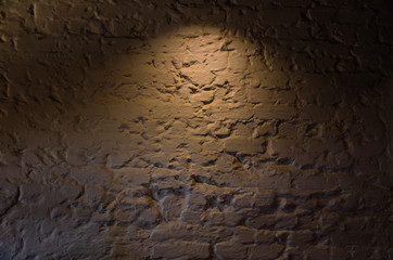 Modern design of a white brick wall with yellow lighting