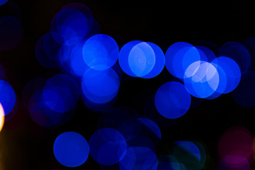 Abstract circular blue light blurred bokeh on dark background
