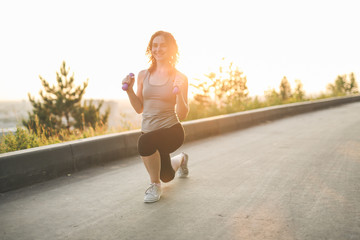 caucasian woman is doing exercises with dumbbells