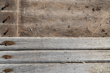 Horizontal narrow long planks. Pattern of wooden boards. Old wooden texture. Dim colours. The planks fill bottom part of the image. Background for text and design