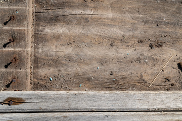 Horizontal narrow long planks. Pattern of wooden boards. Old wooden texture. Dim colours. The planks fill bottom part of the image. Background for text and design