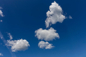 white cumulus clouds on a blue sky as a natural background