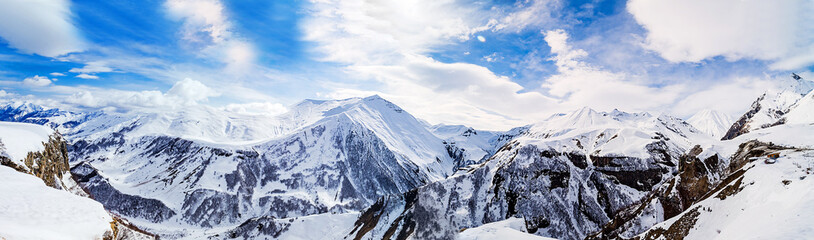 Panorama of snowy mountains. Caucasus mountains, Georgia, view from Gudauri ski resort.