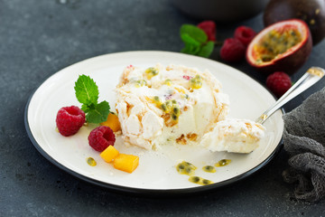 Meringue roulade with raspberries and passion fruit. Pavlova. Dessert. Selective focus