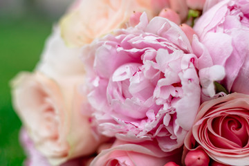 nice and beautiful wedding bouquet of flowers on green grass