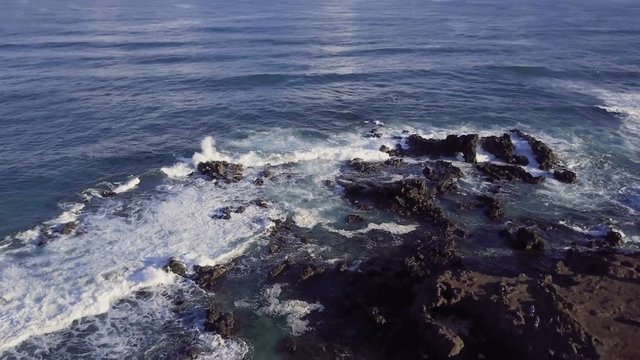 Overhead View Of People Exploring Rugged Ocean Coast Line