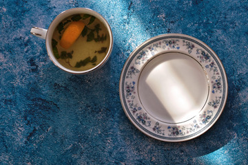 Obraz na płótnie Canvas tea with cake on a blue background