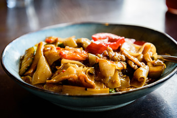 Authentic Thai flat rice stir fried noodles with beef. It is a popular Thailand cuisine also known...