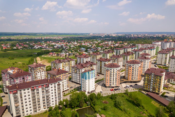 Fototapeta na wymiar Top view of apartment or office tall buildings, parked cars, urban city landscape. Drone aerial photography.
