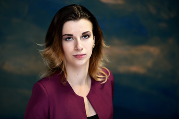 Fototapeta premium Close-up portrait of a pretty young business woman on a colorful background.