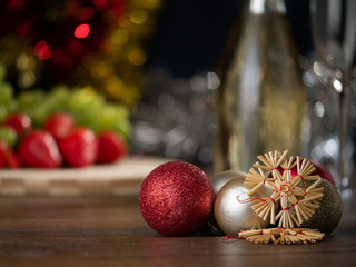 Christmas and new Year's  decoration on blurred background with fresh fruits, sparkling white wine and glitter.