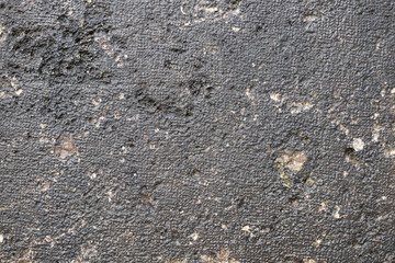 Detail of an old black painted marble wall to use as a background