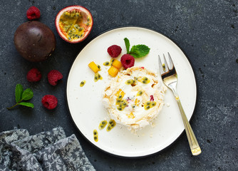 Meringue roulade with raspberries and passion fruit. Pavlova. Dessert. Selective focus