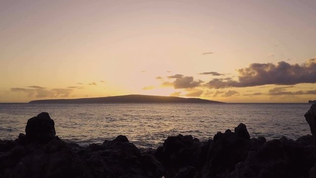 Ocean Sunset With Volcanic Rocks And A Pond Reflection In The Foreground