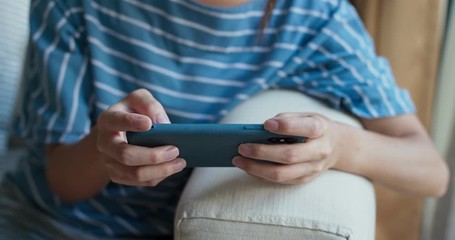 Woman play game on app at home