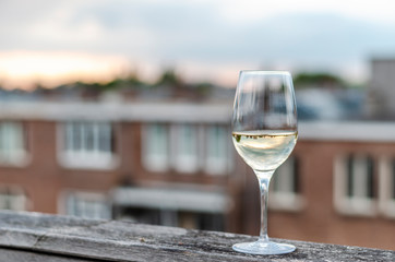 A glass of white wine with the perfect rooftops view.