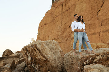 beautiful lovely couple wearing jeans,posing at summer beach