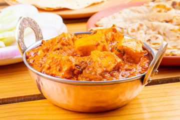 Indian Delicious Spicy Vegetarian Cuisine Paneer Toofani Also Know as Paneer Tufani, Toofani Paneer Masala or Dhaba Style Paneer Masala Served with Tandoori Roti on Wooden Yellow Background