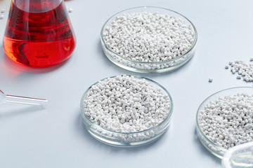 A table in a chemical laboratory with granules and chemical glassware