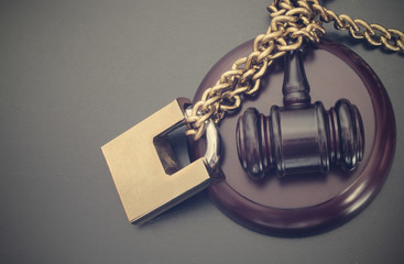 Non-independent justice concept with padlock and gavel
