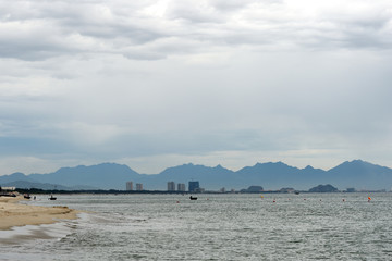 Seascape on the coast of Vietnam with a view of the mountains, boats and the city of Da Nang. Hoi An, Vietnam