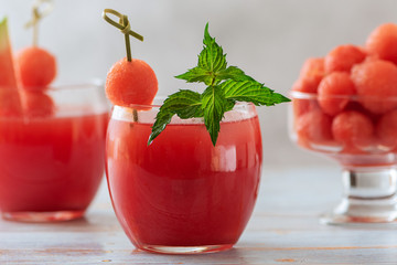 Watermelon drink in glass and watermelon balls. A refreshing summer cocktail