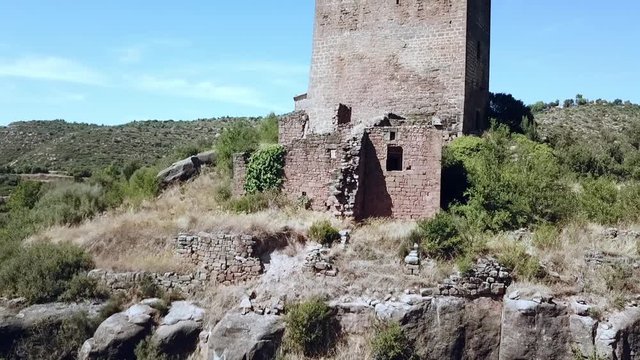 Aerial view of the Riner castle, church and tower near Solsona, Catalonia, Spain, Europe.
Dolly shot, pull back revealing the tower and church.