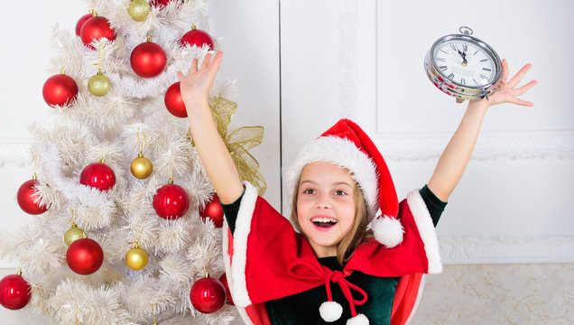 Last minute new years eve plans that are actually lot of fun. Last minute till midnight. New year countdown. Girl kid santa hat costume with clock excited happy face counting time to new year