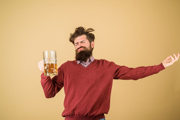 Bad habits. Bearded drunk hipster male holds craft beer. Stylish man with beard holds mug of beer. Drinks, alcohol, leisure and people concept. Bearded man drinking beer from glass at bar or pub.