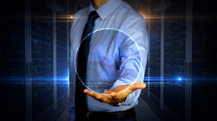 Businessman with nuclear energy symbol hologram