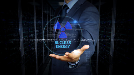 Businessman touch screen with nuclear energy symbol hologram