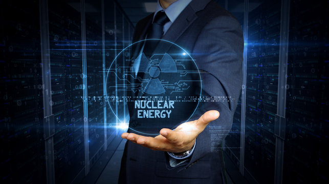 Businessman touch screen with nuclear energy symbol hologram