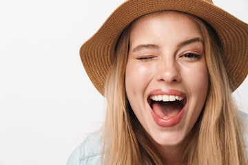 Happy smiling optimistic young pretty woman wearing hat posing isolated over white wall background.