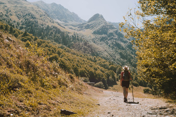 A woman hiking in the Aran valley in Spain, exactly in Artiga de Lin,