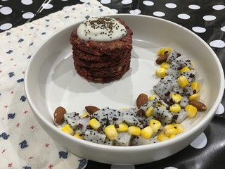 Red velvet pancakes with yogurt mixed dragon fruit and corn and almonds