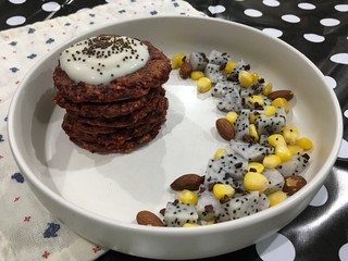 Red velvet pancakes with yogurt mixed dragon fruit and corn and almonds