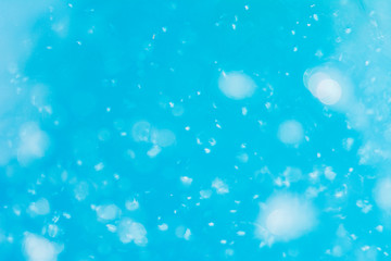 abstract background in blue colors light reflected in water looks weird with air bubbles and bokeh  with blur