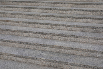 Close-up of grey granite tile staircase in daylight